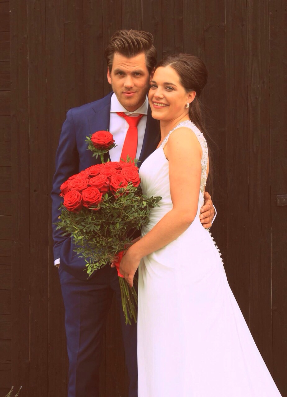 Newly weds with Red Noami roses bridal Bouqet
